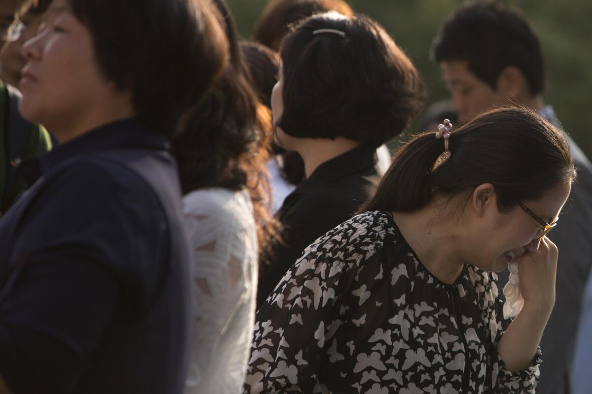 Family members of victims of the Sewol ferry disaster leave the Gwangju District Court in the city of Gwangju, South Korea, on Tuesday.