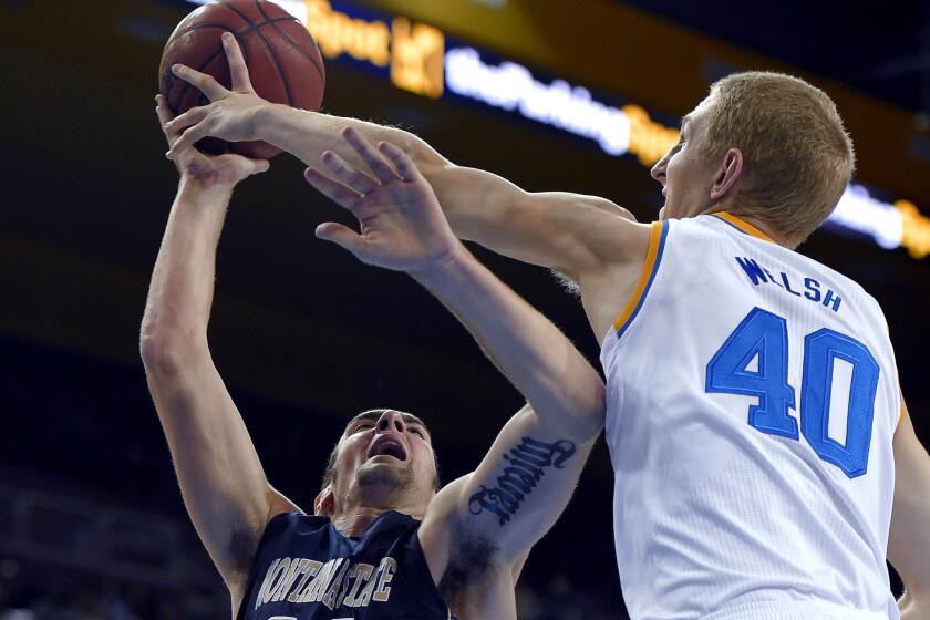 UCLA center Thomas Welsh blocks a shot by Montana State forward Danny Robison in the first half Friday night.