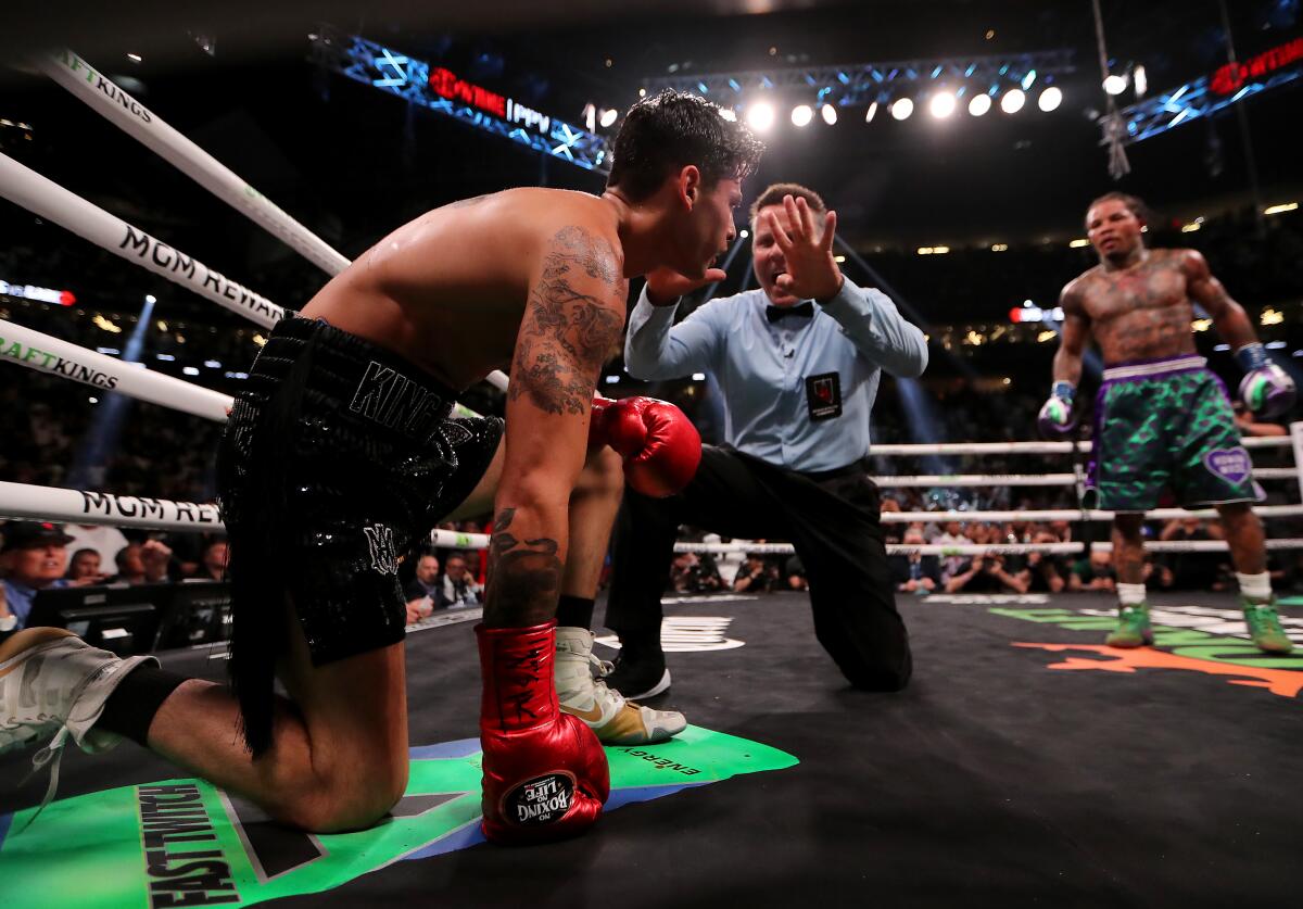 Ryan Garcia is counted out by referee Thomas Taylor after taking a body shot from Gervonta Davis 