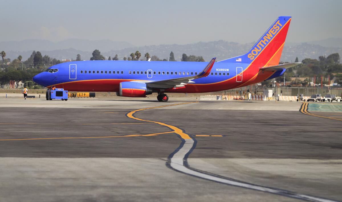 A Southwest Airlines jet at LAX in September 2014. A passenger aboard a Southwest flight was removed Oct. 18 after allegedly attacking another person on board.