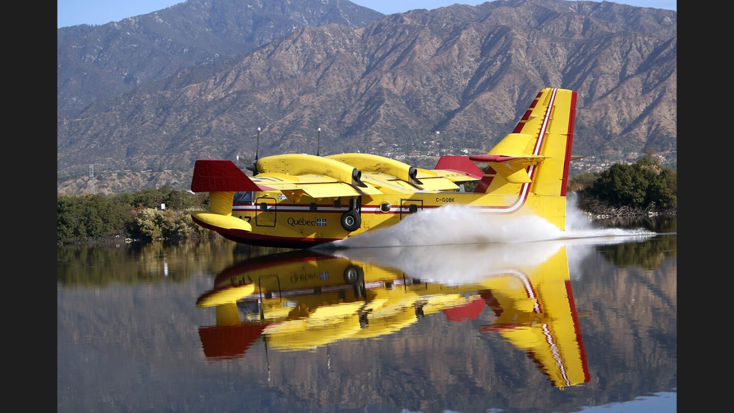 A Super Scooper water dropping airplane picks up a load of water at Santa Fe Dam Recreation Area in Irwindale as it fights a stubborn fire near Mt. Wilson Observatory on Tuesday, Oct. 17, 2017.