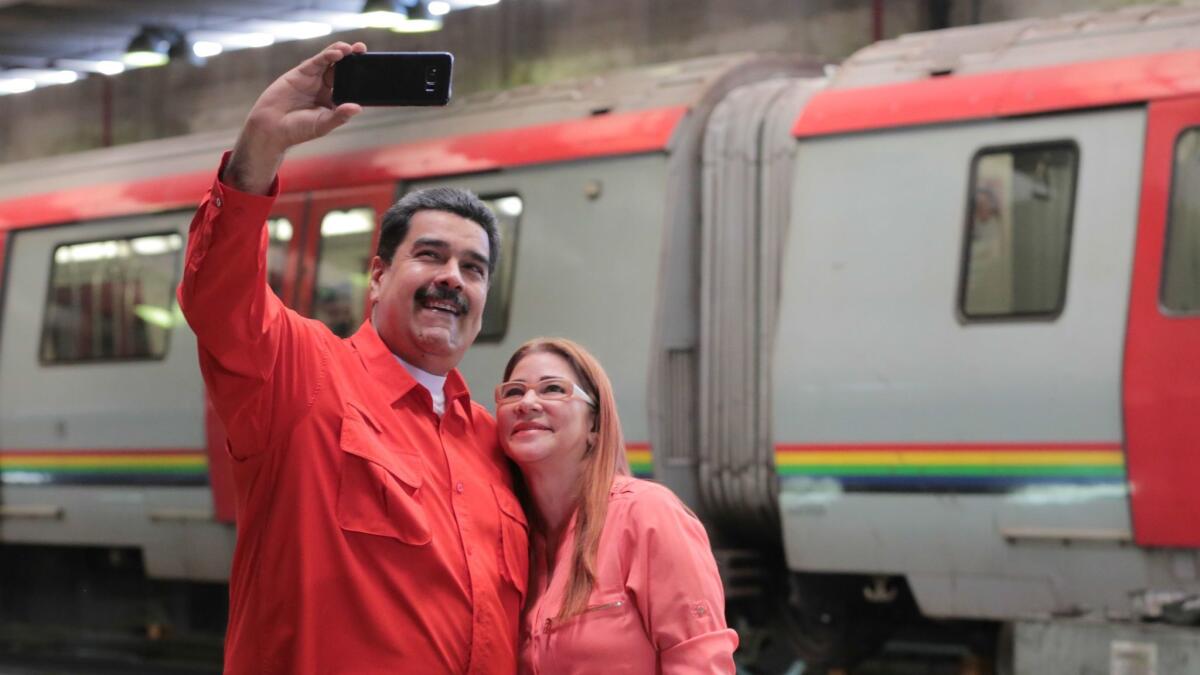 Venezuelan President Nicolas Maduro takes a selfie with his wife Cilia Flores at an event in Caracas on Jan. 24. Maduro confirmed he will seek a second term as president.
