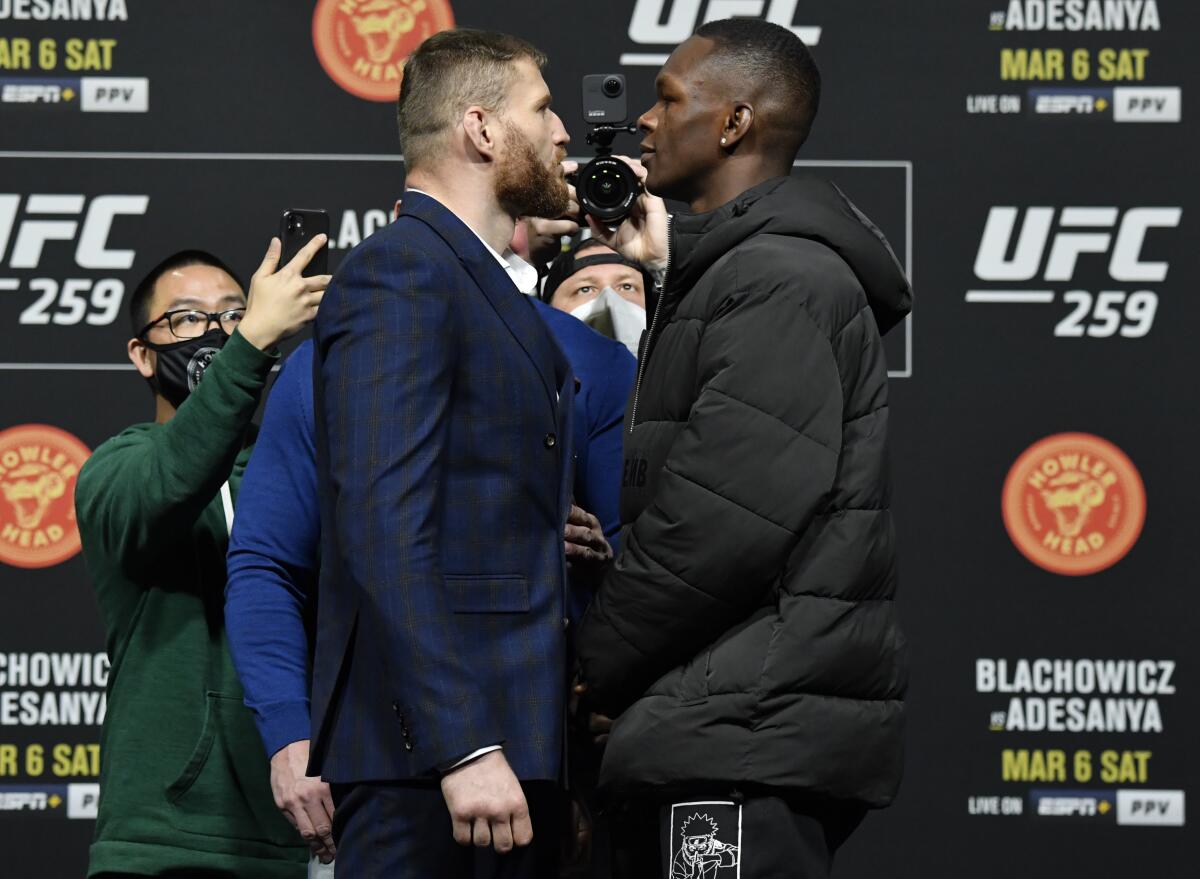 Jan Błachowicz, left, and Israel Adesanya face off during the UFC 259 press conference in Las Vegas on Thursday.