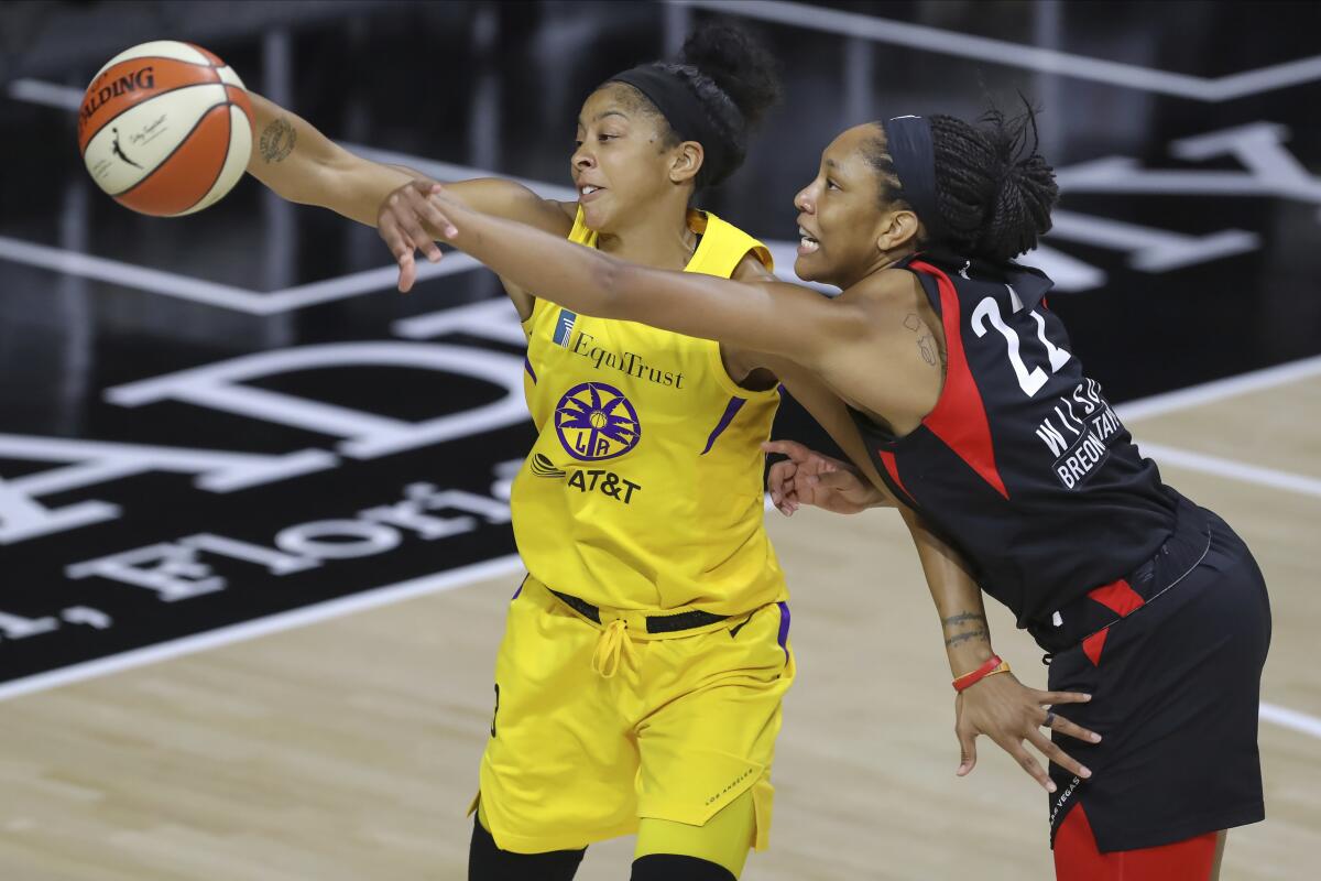 Aces forward A'ja Wilson deflects a pass intended for Sparks forward Candace Parker during their game Sept. 12, 2020.