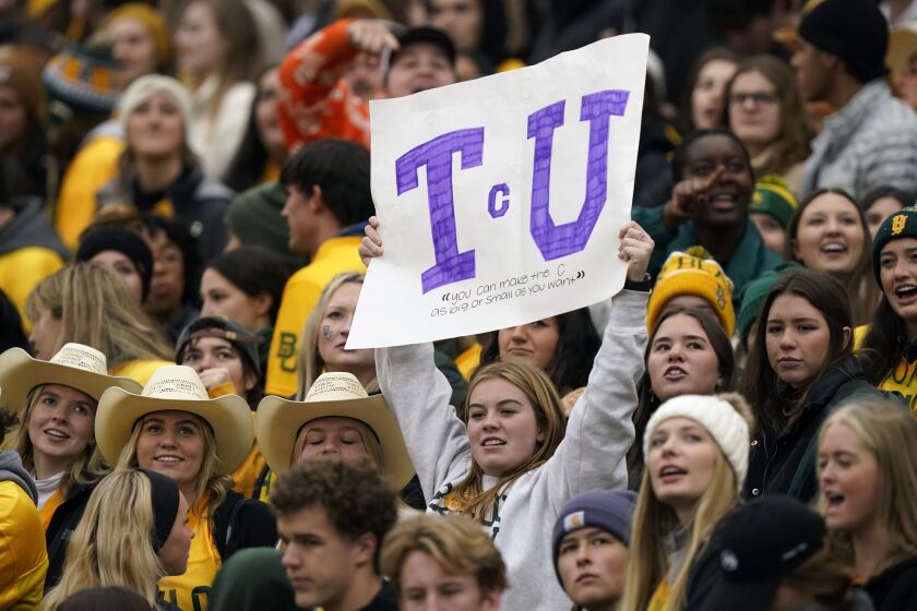Amongst Baylor fans a lone TCU fan holds up a sign during the first half of an NCAA college football game in Waco, Texas, Saturday, Nov. 19, 2022. (AP Photo/LM Otero)
