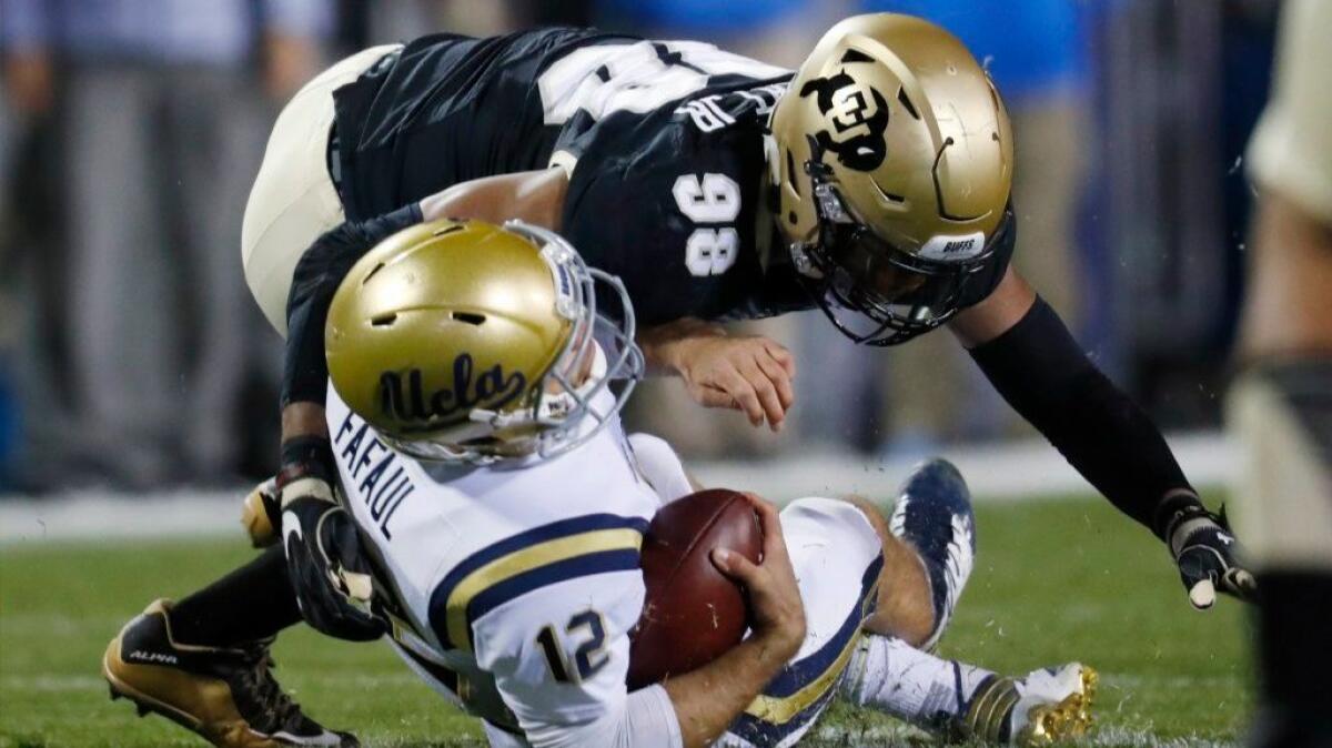 Colorado linebacker Jimmie Gilbert hits UCLA quarterback Mike Fafaul in the first half of a game on Nov. 3.