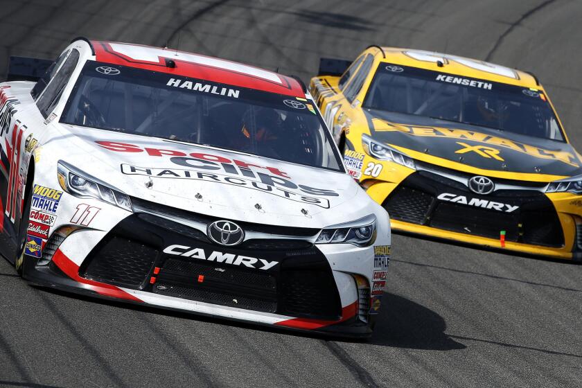 NASCAR drivers Denny Hamlin, in the No. 11 Sport Clips Toyota, and Matt Kenseth, in the No. 20 DeWalt Toyota, run side by side during the Sprint Cup Series Auto Club 400 in Fontana on Sunday.