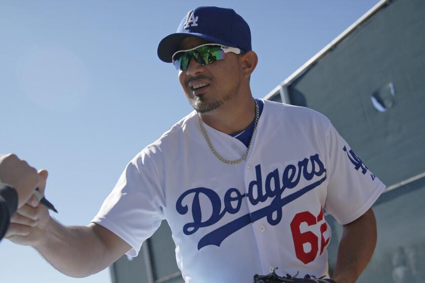 Dodgers reliever Joel Peralta signs autographs for fans after a spring training workout session in Phoenix on Feb. 25. Peralta is returning from the disabled list.