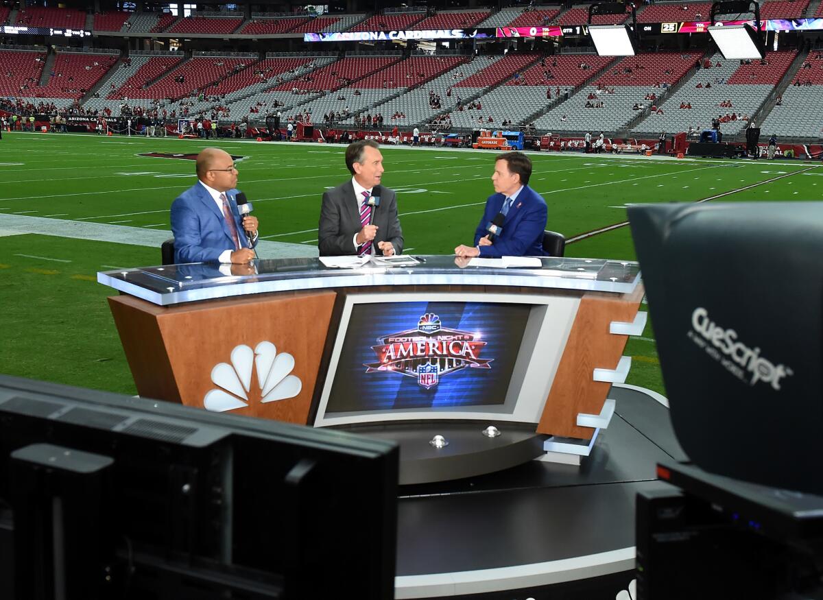 The dispute between NBCUniversal and Charter centers on proposed price hikes for the NBC channels, according to people familiar with the talks. Above, NBC "Sunday Night Football" commentators Mike Tirico, left, Cris Collinsworth and Bob Costas before a game in September.