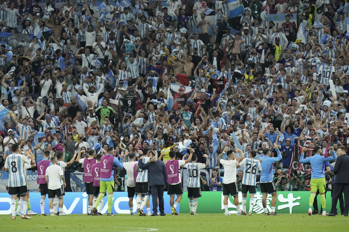 Argentinian players acknowledge fans after winning the World Cup grou