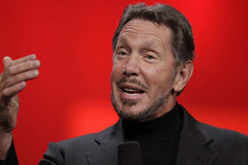 FILE - In this Oct. 2, 2012 file photo, Oracle CEO Larry Ellison gestures while giving a keynote address at Oracle OpenWorld in San Francisco. Tesla is naming Ellison and an executive from Walgreens to its board as part of a settlement with U.S. regulators who demanded more oversight of CEO Elon Musk. The company said Friday, Dec. 28, 2018, that Ellison and Kathleen Wilson-Thompson are the new independent directors, effective immediately. (AP Photo/Eric Risberg, File)
