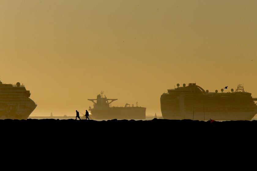 LONG BEACH, CA. - JAN. 14, 2021. Fishermen set up on the Long Beach side of the San Gabriel River jetty as the sun sets after an unseasonably warm winter day on Thursday, Jan. 14, 2021. (Luis Sinco/Los Angeles Times)