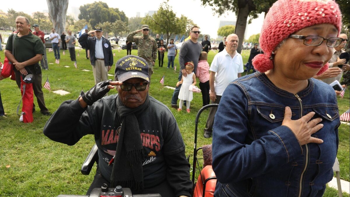A Marine Corps veteran and his wife participate in the Memorial Day ceremony at the Los Angeles National Cemetery in Los Angeles on May 31, 2018. The pair have been living in their car for the past two years.