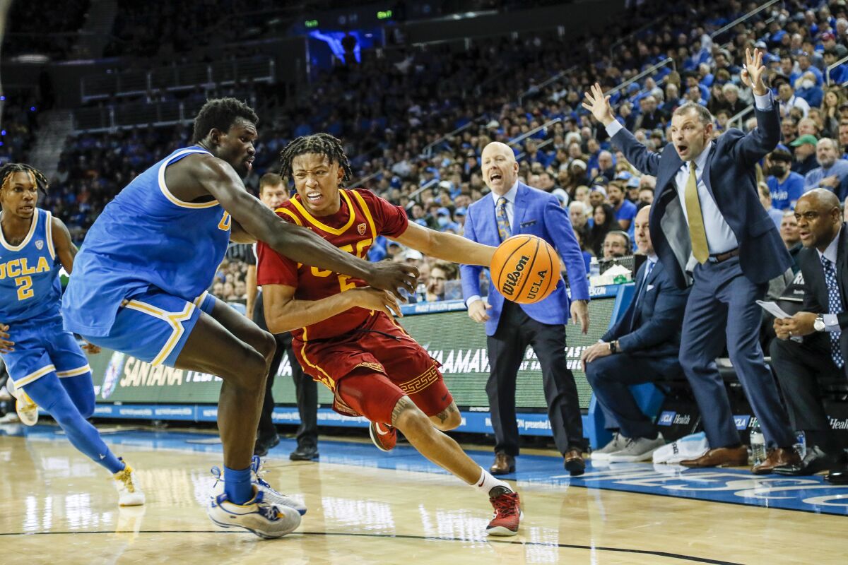 USC guard Boogie Ellis drives past UCLA forward Adem Bona in the first half at Pauley Pavilion.