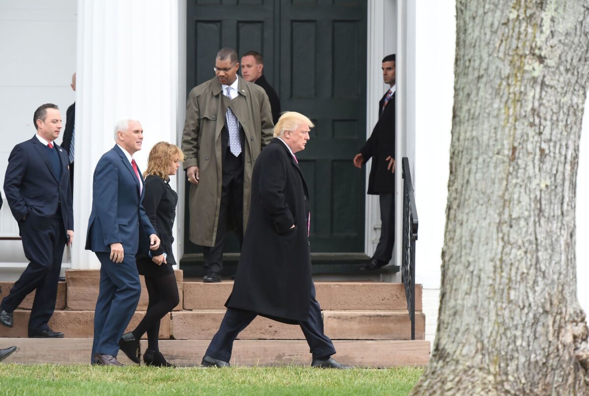 President-elect Donald Trump, front, and Vice President-elect Mike Pence leave the Lamington Presbyterian Church after Sunday services in Bedminster, N.J., on Sunday.