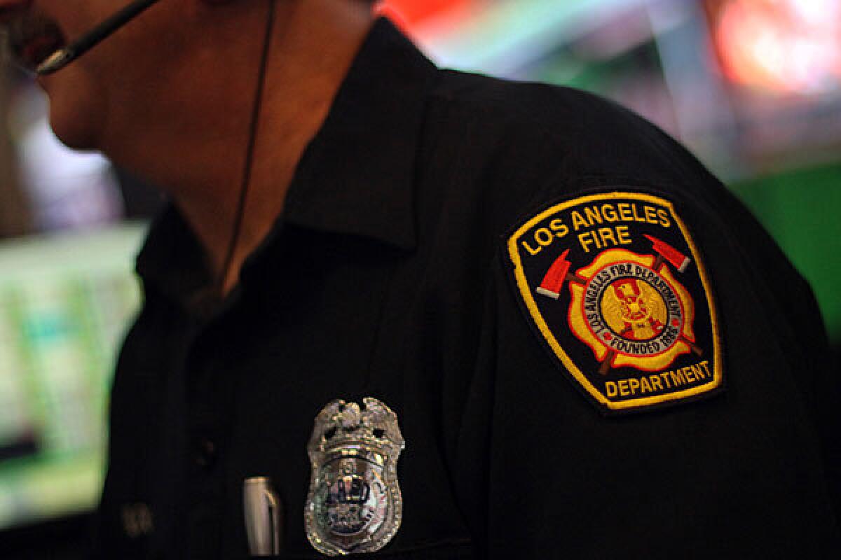 A Fire Department dispatcher works the phone in 2012.