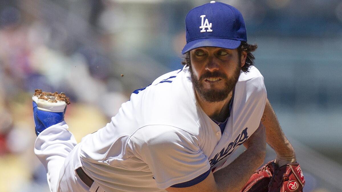 Dodgers starter Dan Haren delivers a pitch during the first inning of Sunday's loss to the Milwaukee Brewers.