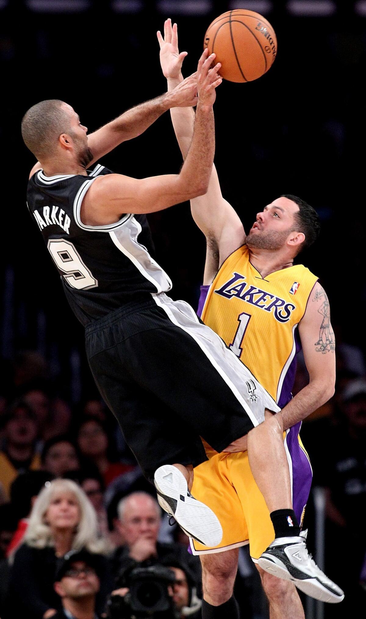 San Antonio Spurs guard Tony Parker, left, passes in front of Lakers guard Jordan Farmar at Staples Center.