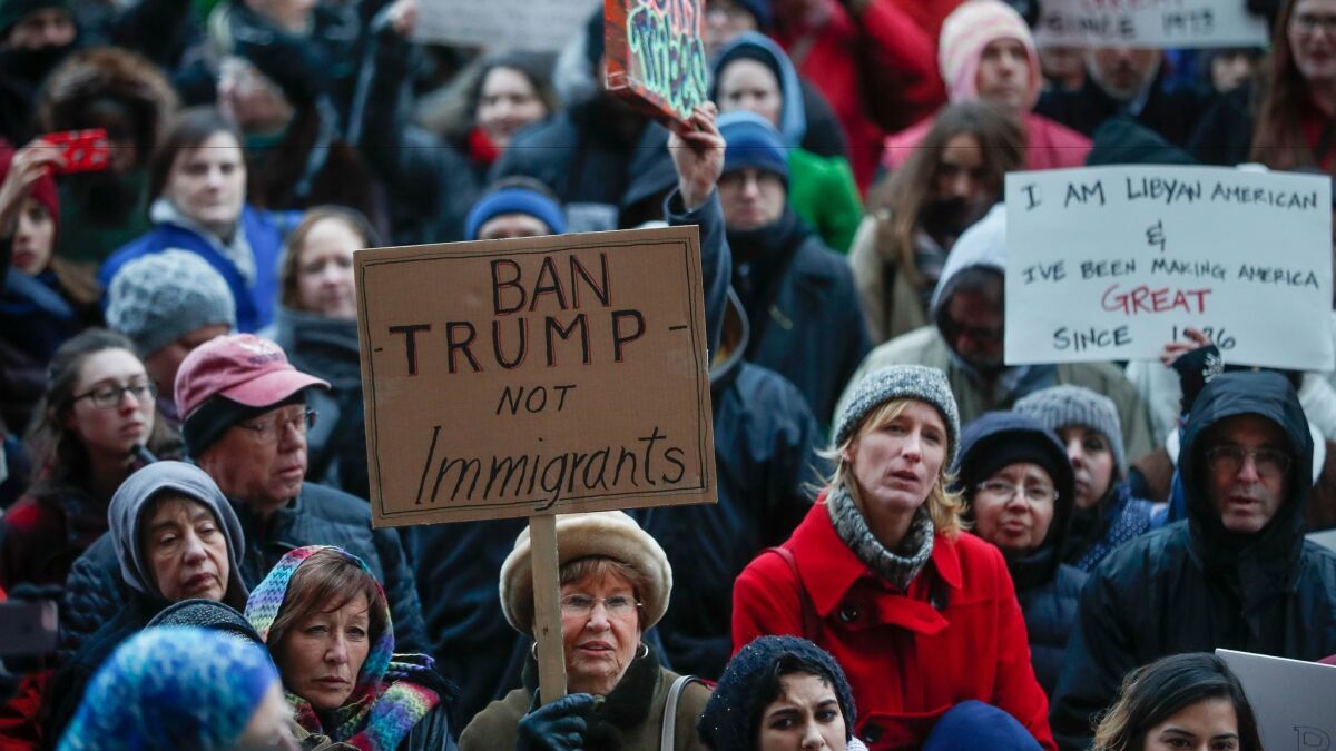 Demonstrators gather in solidarity outside Cincinnati City Hall against President Trump's executive order temporarily banning immigrants from seven Muslim-majority countries from entering the U.S. (John Minchillo / Associated Press)