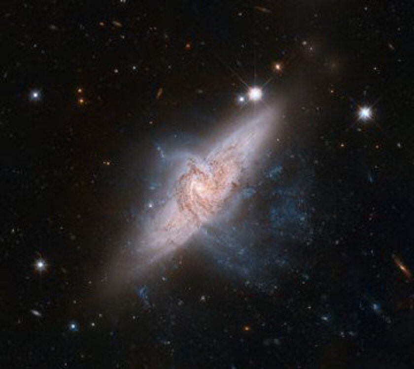 Two galaxies that appear to be colliding are actually tens of millions of light-years apart.