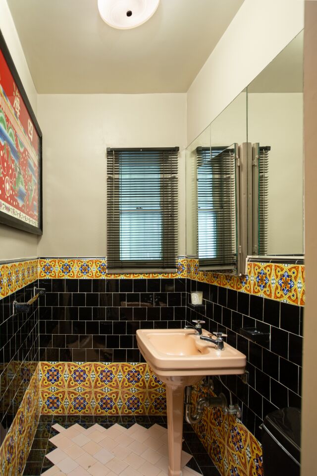 Decorative tilework draws the eyes in the powder room.
