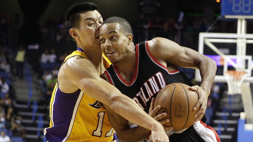 Portland Trail Blazers guard C.J. McCollum, right, collides with Lakers guard Jeremy Lin during the second half of the Lakers' 94-86 exhibition win Wednesday.