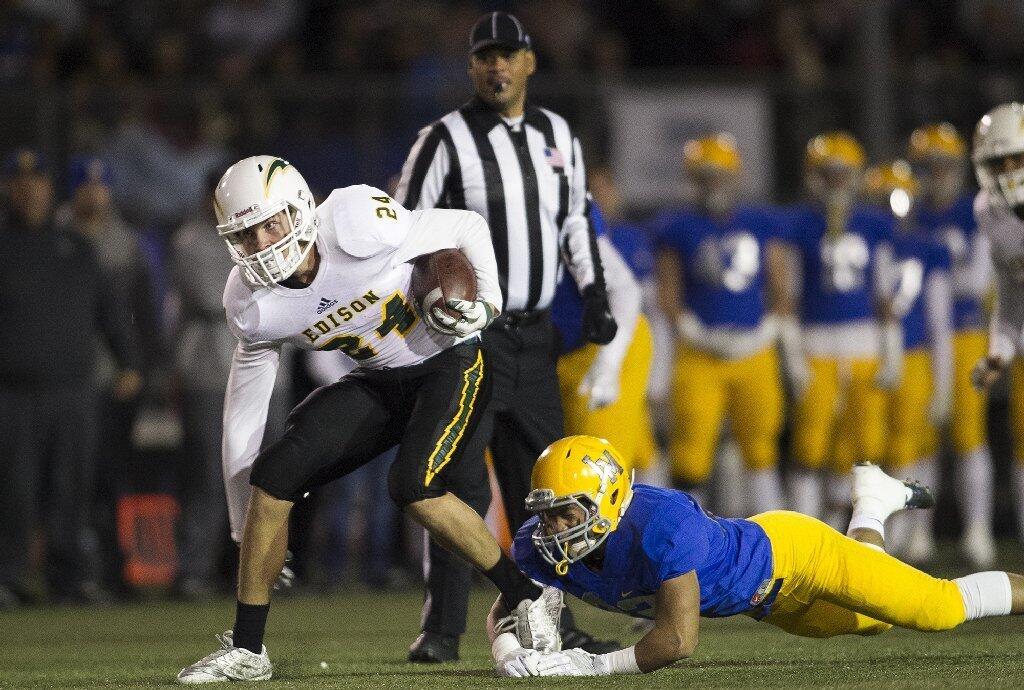 Edison's Jack Carmichael breaks a tackle from La Mirada's Penieli Lauago during the CIF Southern Section Division 3 championship game at La Mirada High School on Friday.
