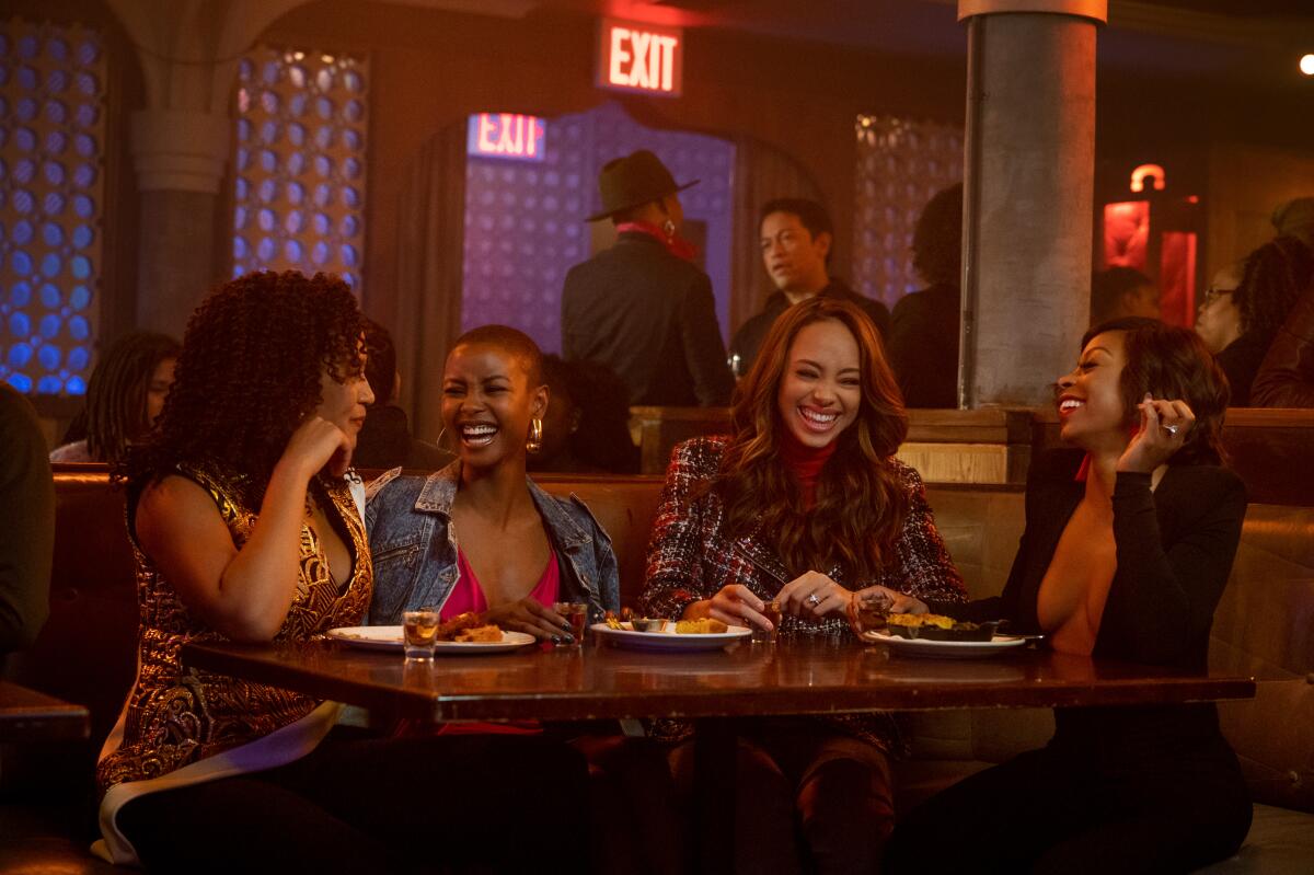 Four women laugh in a restaurant booth in Starz's upcoming "Run the World."