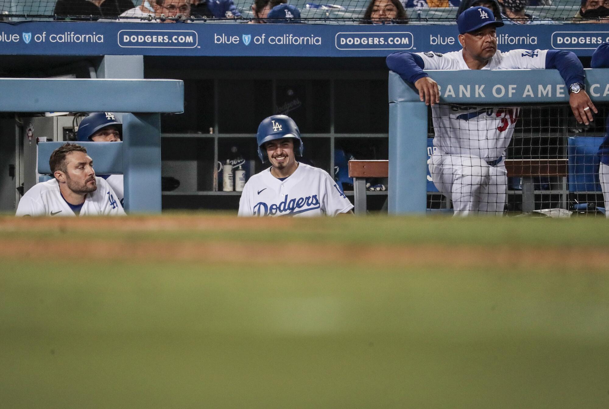 Dodgers bat boy Branden Vandal smiles as he stands in the dugout during a game against the Atlanta Braves.