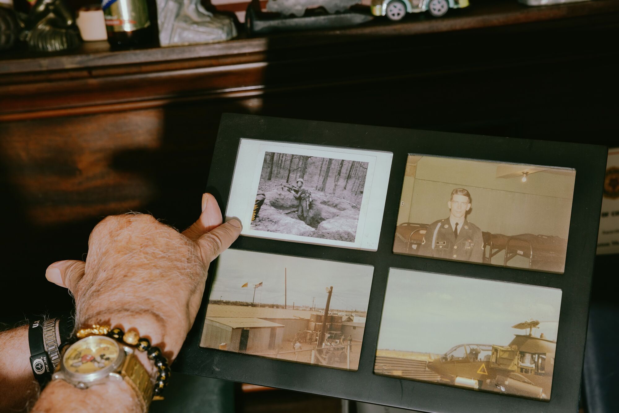 Gene Ulrich shows a photo of himself in Army training.