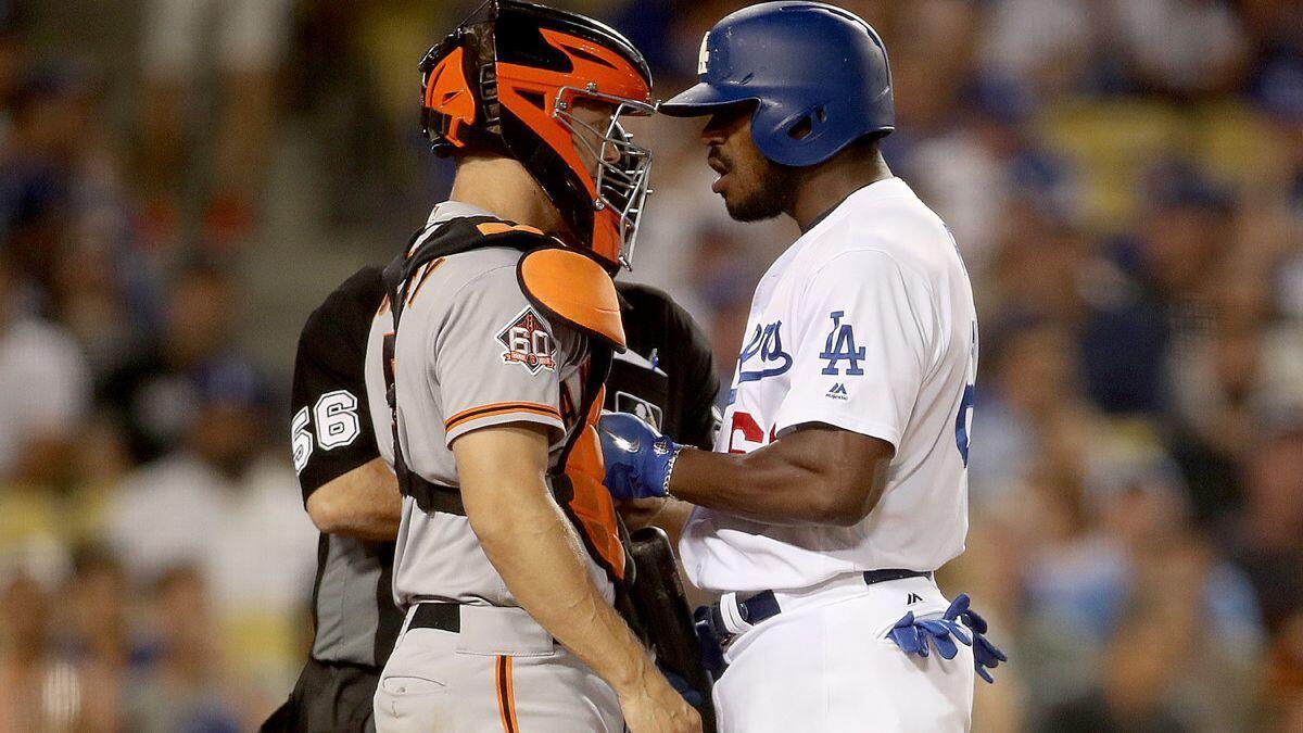 Dodgers outfielder Yasiel Puig shoves San Francisco Giants catcher Nick Hundley at the plate in the bottom of the seventh inning at Dodger Stadium on Tuesday.