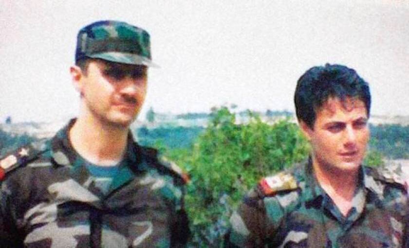 An undated photo taken in Syria shows Brig. Gen. Manaf Tlas, right, with President Bashar Assad.