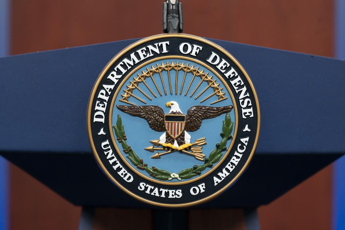 The seal of the Department of Defense on a podium at the Pentagon.
