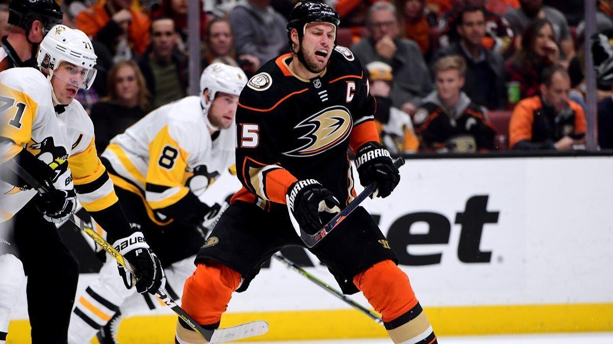 Ducks' Ryan Getzlaf (15) loses the puck as he is checked by Pittsburgh Penguins' Evgeni Malkin (71) during the first period at Honda Center on Wednesday.