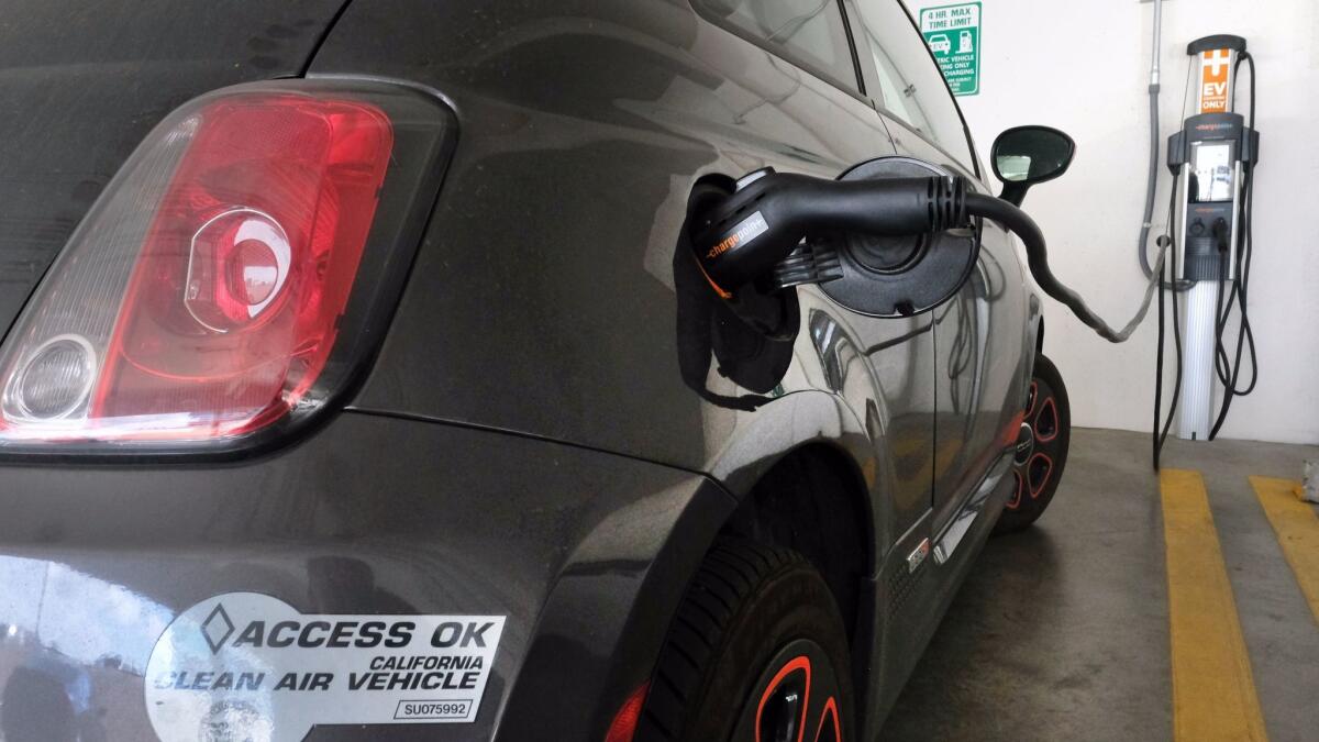 An electric Fiat is plugged into a charging station in Los Angeles.