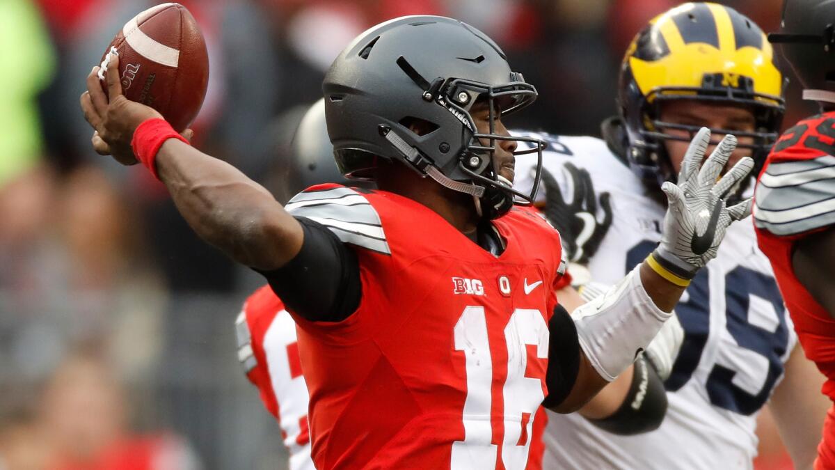 Ohio State quarterback J.T. Barrett unloads a pass against Michigan in the fourth quarter Saturday.