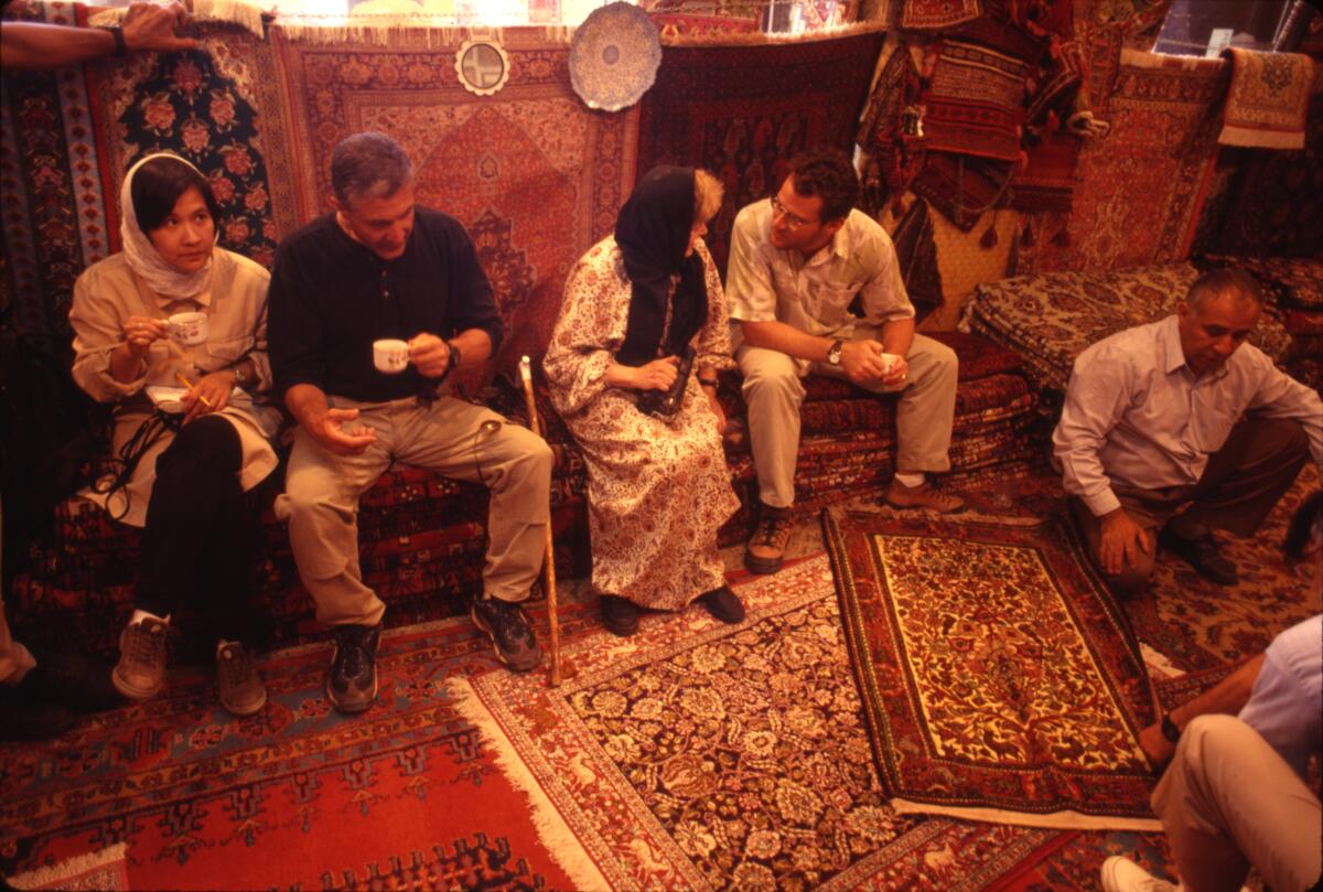 At a carpet vendor's shop in Isfahan, we took tea. At right, you can see the salesman talking. Iran, 1998.