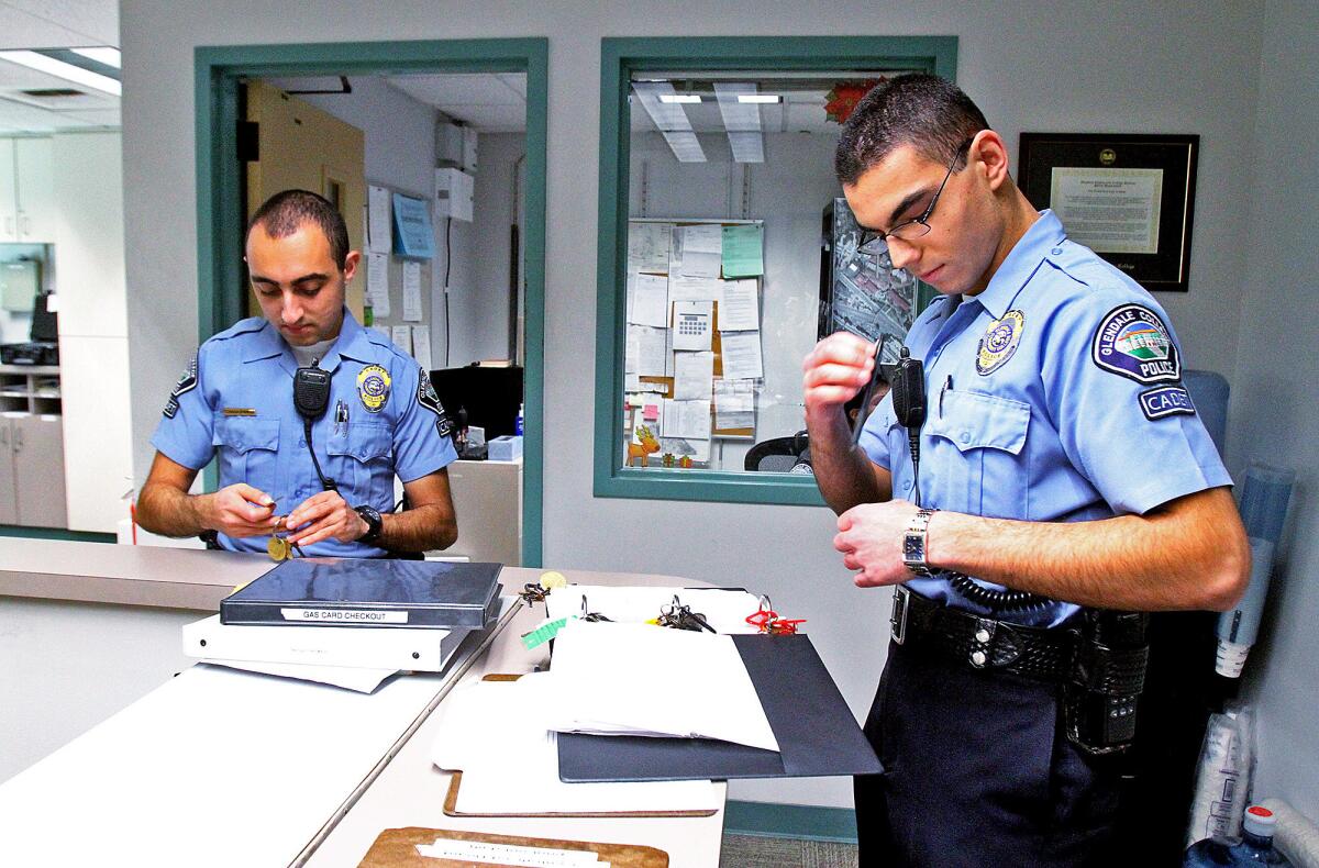 Glendale Community College Police Cadets Hovig Tchagaspanian and Artsroun Darbinian gather keys at the beginning of their shift on a holiday shift when the campus is closed on Tuesday, December 24, 2013. The two will work together today from 3:00 until midnight when their shift ends. (