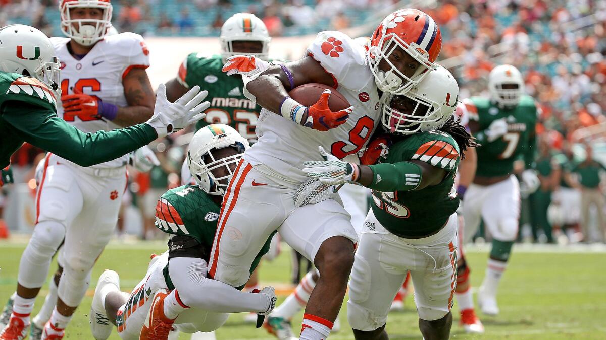 Clemson running back Wayne Gallman drags Miami defenders across the goal line on a five-yard touchdown run in the first quarter Saturday.