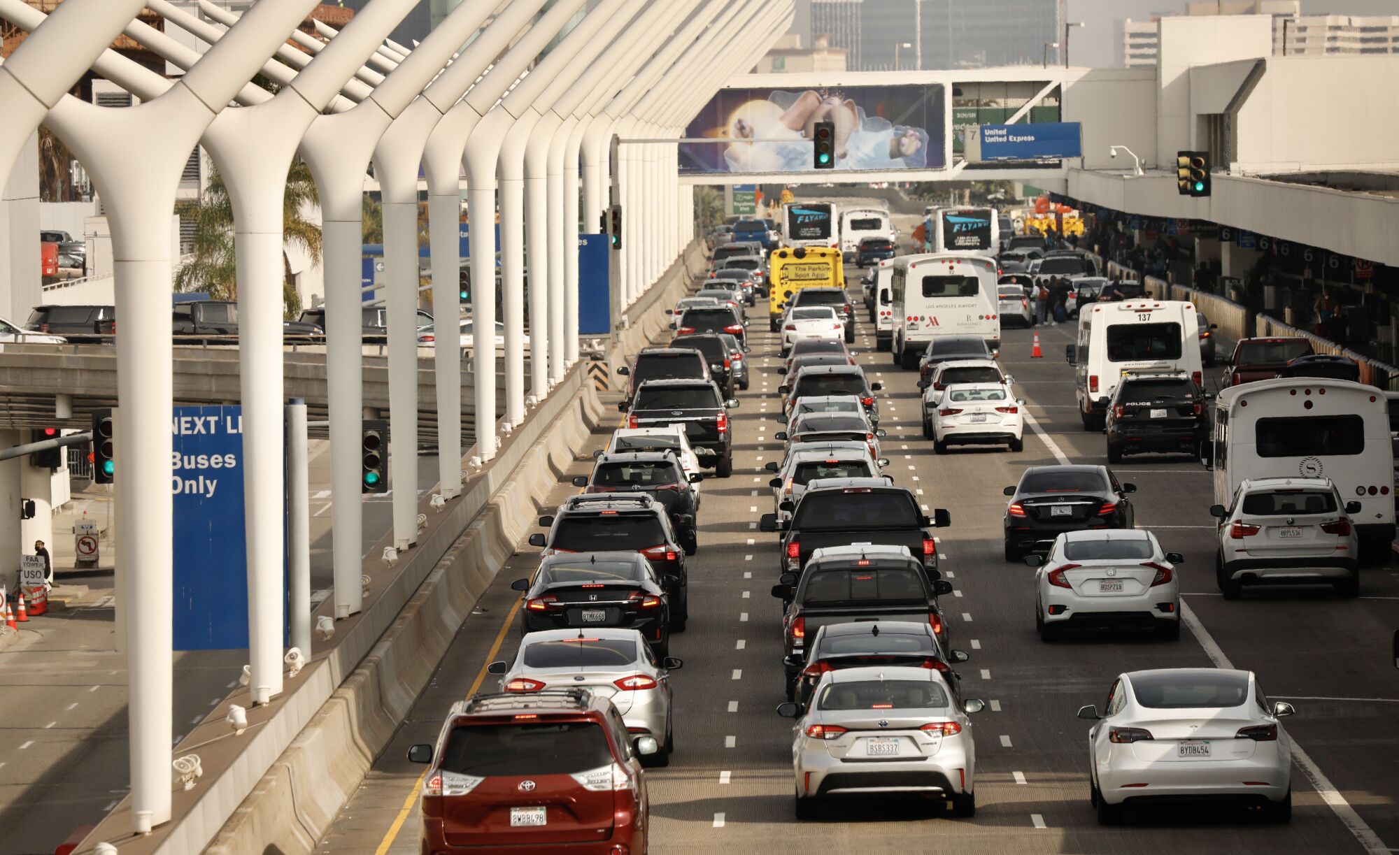 Lines of cars work their way around the horseshoe at Los Angeles International Airport.