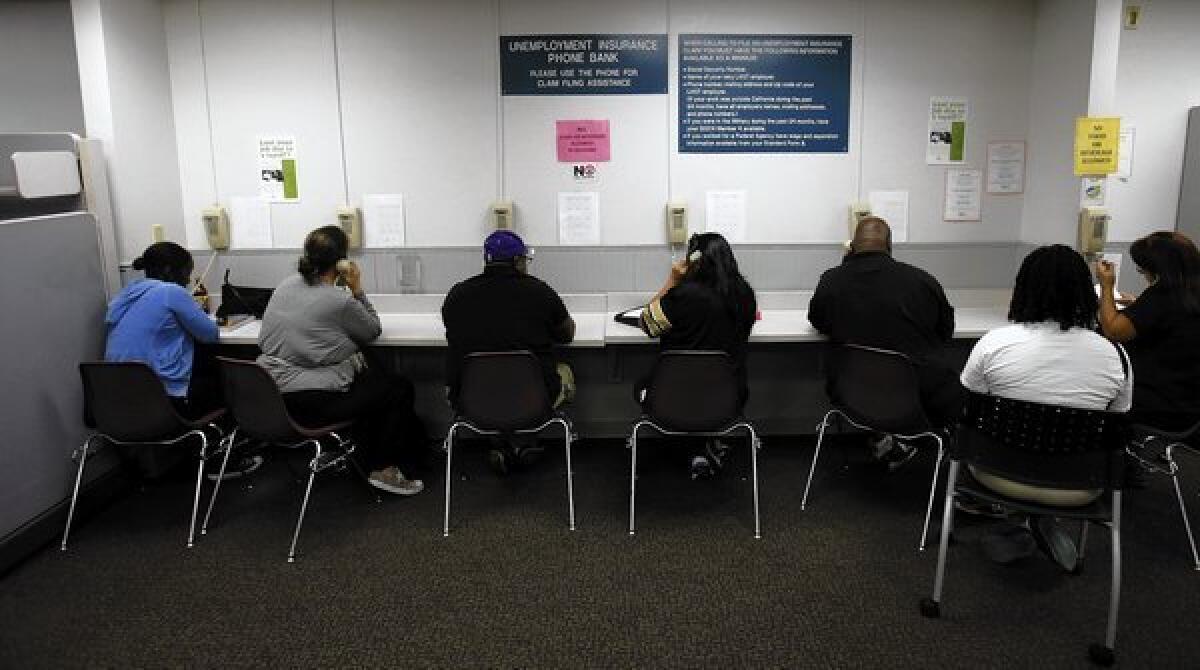 Visitors use the Unemployment Insurance phone bank at the California Employment Development Department office in Sacramento.