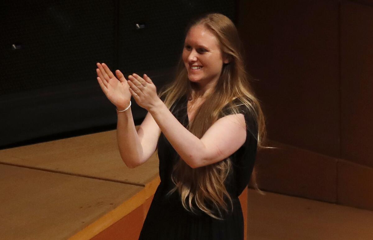 Composer Gabriella Smith applauds the L.A. Phil string quartet that performed her "Carrot Revolution" at the Green Umbrella concert Tuesday at Walt Disney Concert Hall.