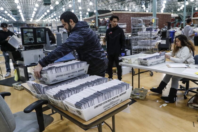 Industry, CA, Wednesday, November 9, 2022 - Ballots are received, sorted and verified at the LA County ballot processing facility. They are then shipped to Norwalk to be counted. Ballot envelopes are scanned for signature verification at this station. (Robert Gauthier/Los Angeles Times)