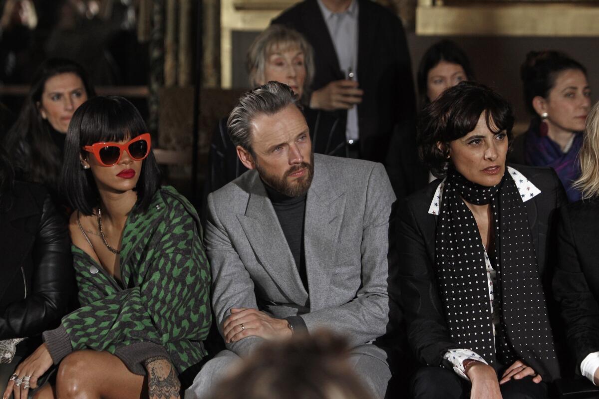 Singer Rihanna, left, Stella McCartney's husband Alasdhair Willis and model Ines de la Fressange attend Stella McCartney's ready-to-wear fall/winter 2014-2015 fashion collection in Paris earlier this month.