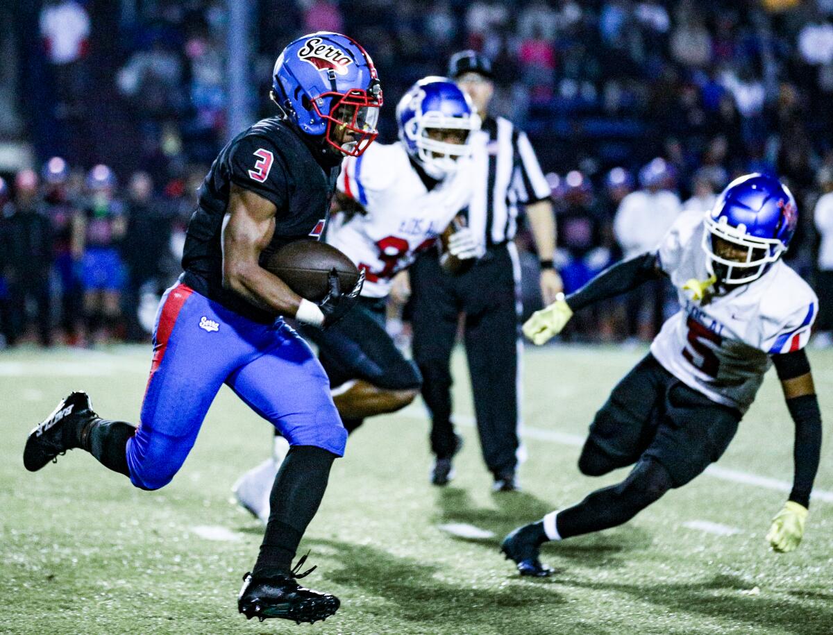 Cincere Rhaney of Gardena Serra tries to evade two Los Alamitos defenders as he heads up field.