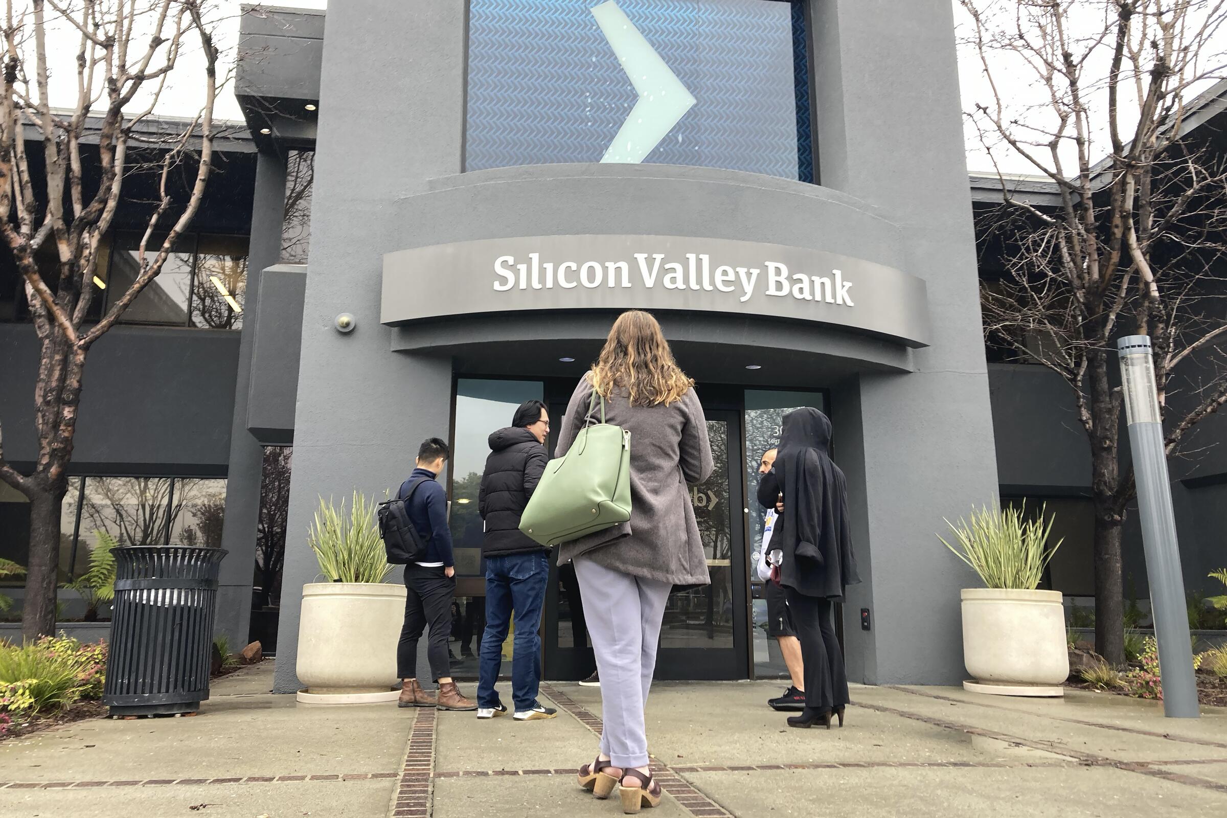 Customers stand outside Silicon Valley Bank.