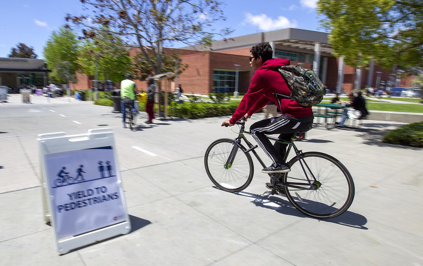 A bicyclist rides on the "core campus loop" for bicyclists and skateboarders at Orange Coast College in Costa Mesa on Thursday.