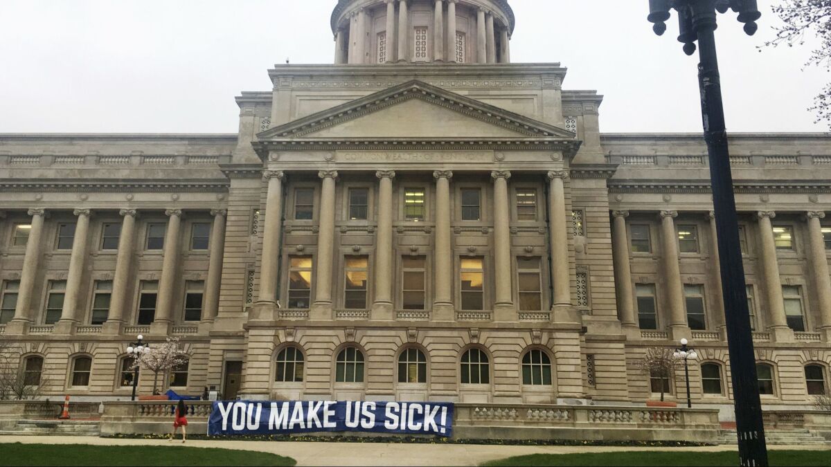 A sign hangs from the Kentucky Capitol on Monday in Frankfort, Ky.