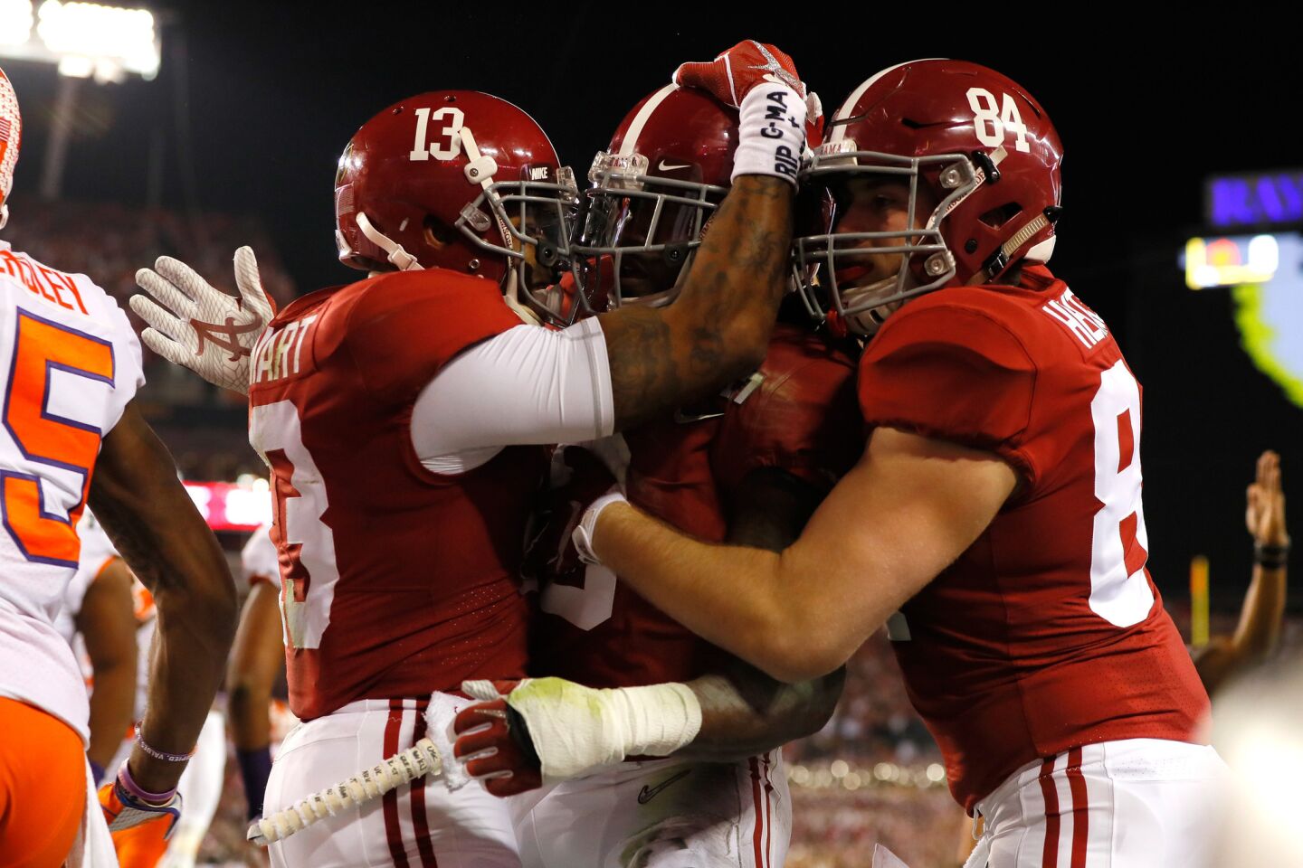 Alabama running back Bo Scarbrough is congratulated by teammates ArDarius Stewart (13) and Hale Hentges (84) after scoring on a 25-yard run during the first quarter Monday.