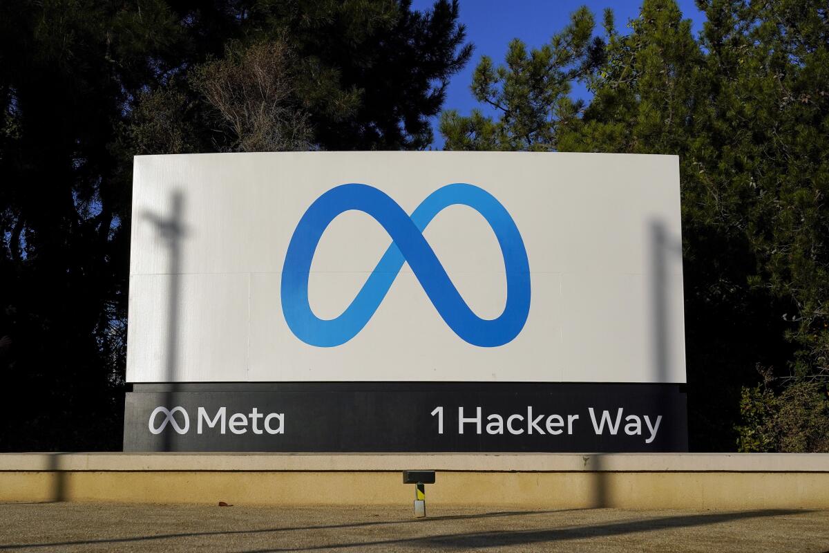 Meta's blue logo that resembles an infinity symbol is on a sign at the company's headquarters in Menlo Park, Calif.
